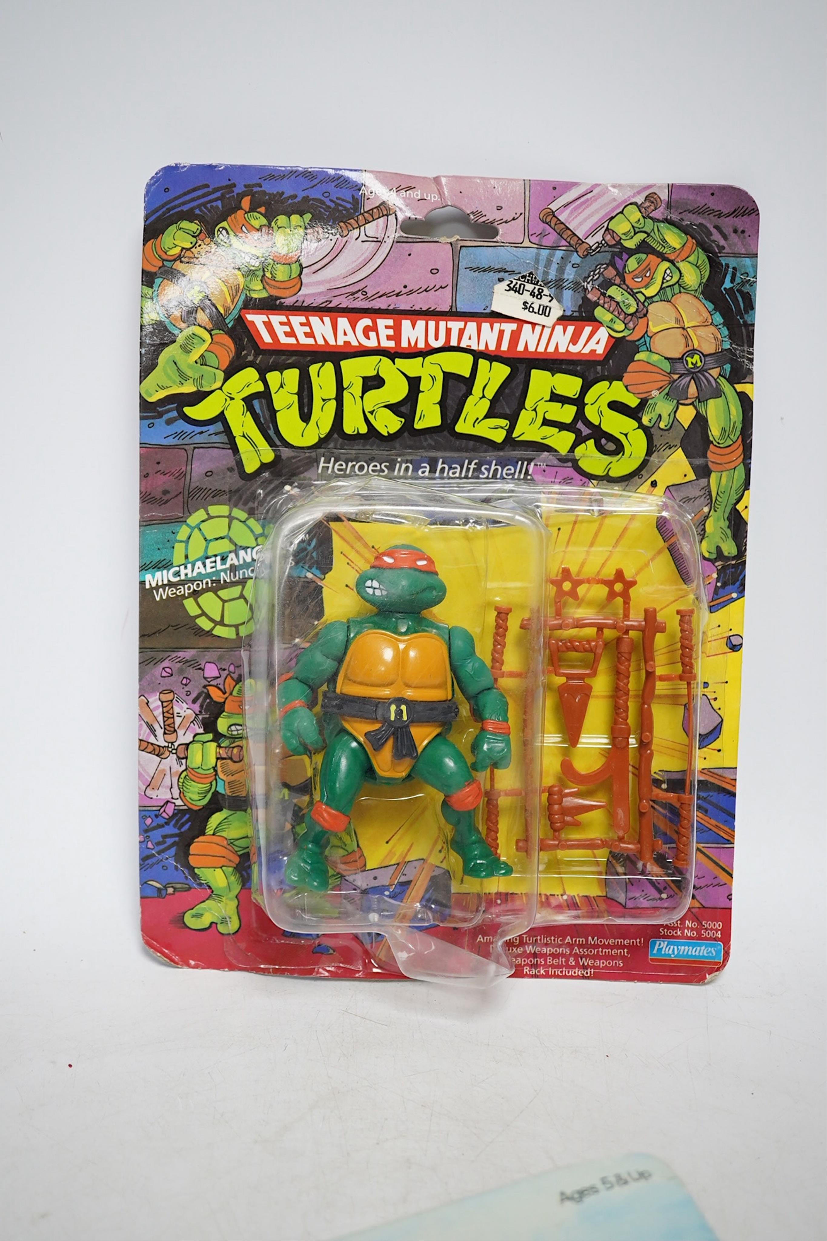 A Playmates Teenage Mutant Ninja Turtles figure of Michaelangelo, dated 1988, a Teenage Mutant Hero Turtles packeted ‘Teasers’, dated 1990, and a Matchbox Ring Raiders toy. Condition - fair to good, some creases to backi